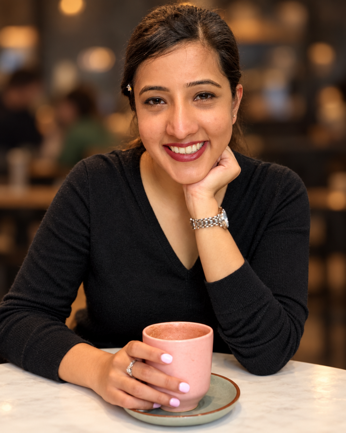 Gunjit smiling with a coffee